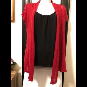 Cardigan red sweater with black tank top.